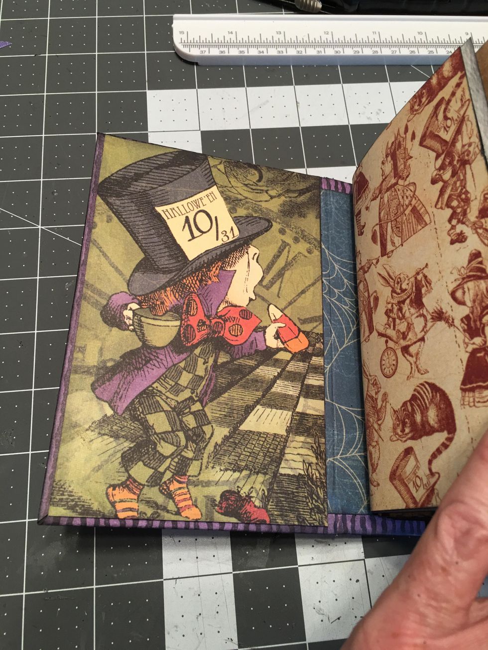 Select a cut apart card or an image on the paper that you'd like to use for your inside front cover like the Mad Hatter shown here.