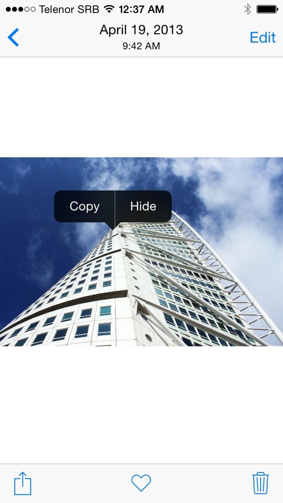 Select any photo from your library, tap and hold with your finger until the option to hide the photo appears. Now simply tap on hide.