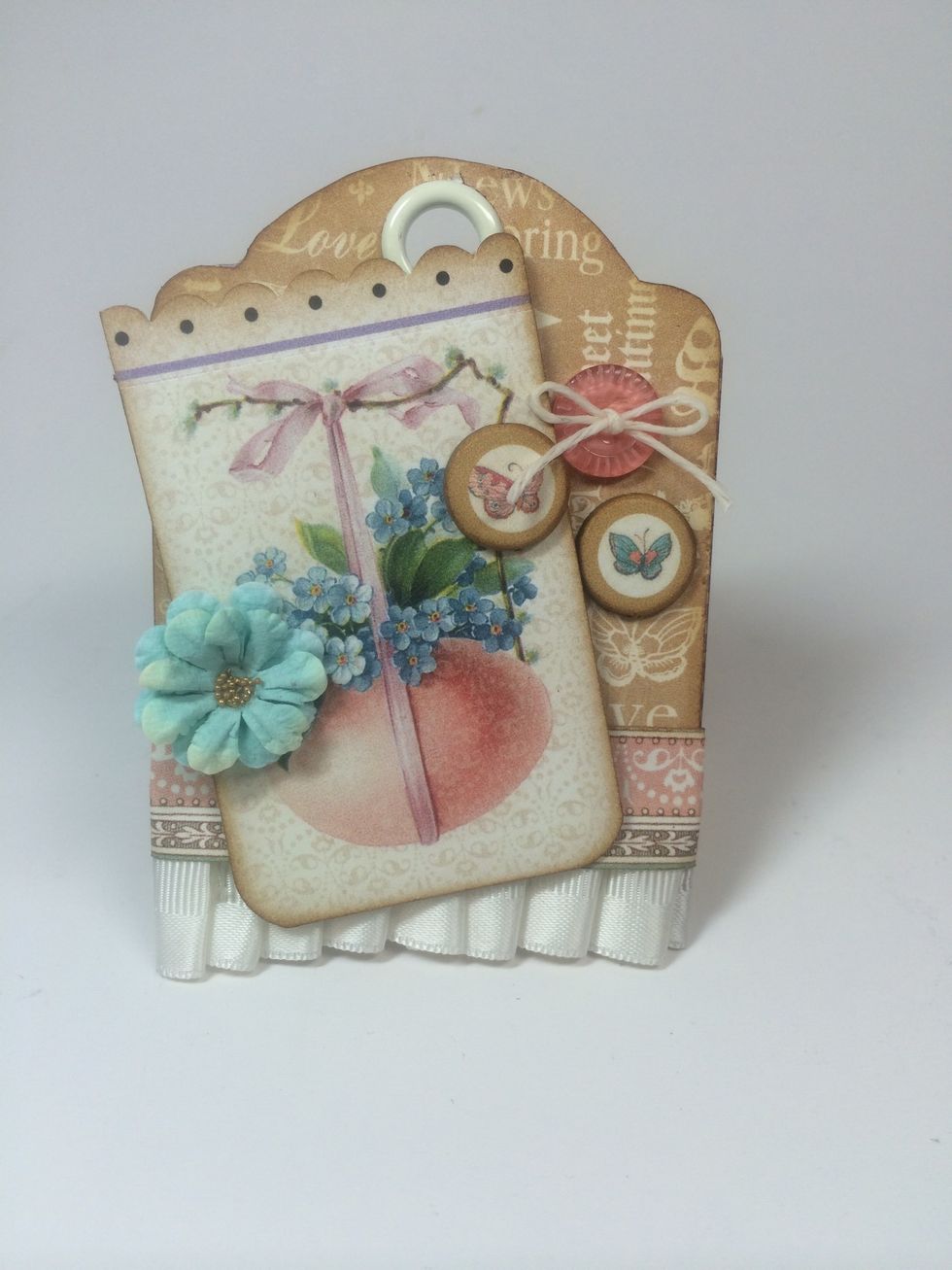 Select embellishments you like and attach to your tags.
