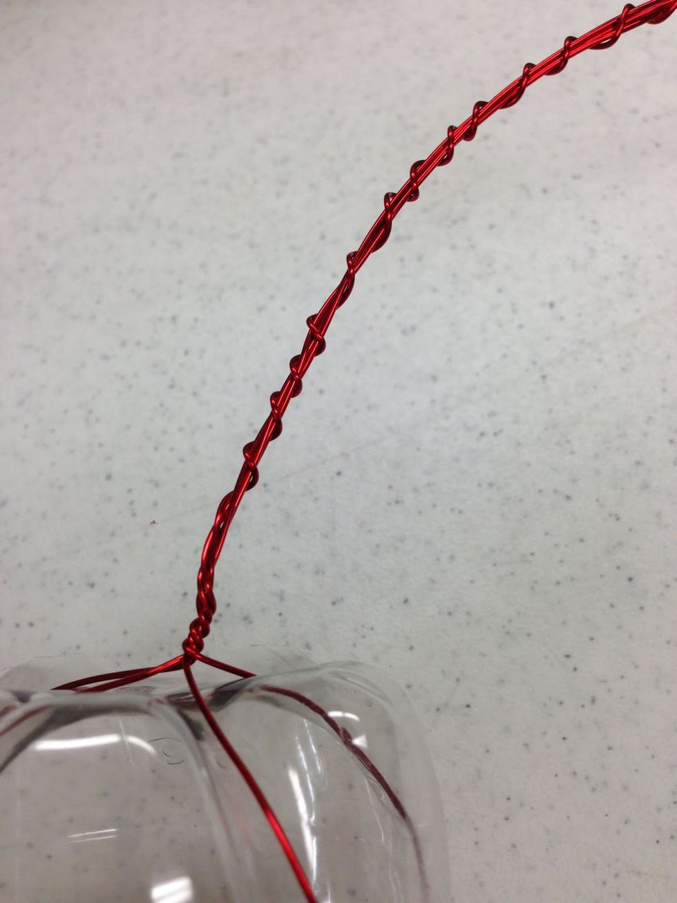 Select one of the strands of wire to wrap around the rest of the bundle as pictured.