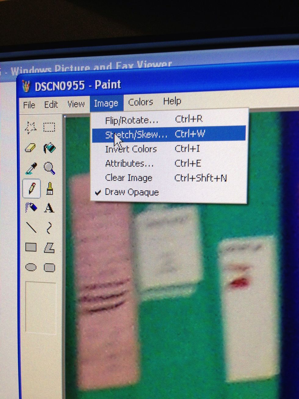 Select "stretch/skew". On newer versions of paint, select "resize"