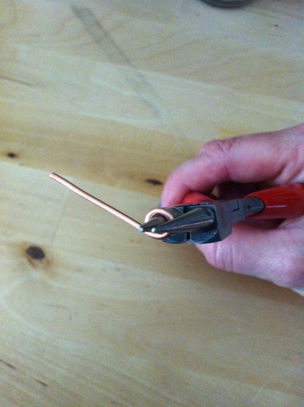 Select the 1 3/4" piece of wire and use the round nose pliers to make a loop at one end.