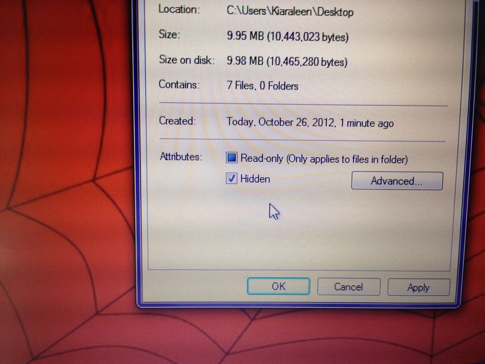 Select the Hidden box on the general settings of the folder under the attributes area. Then click ok.