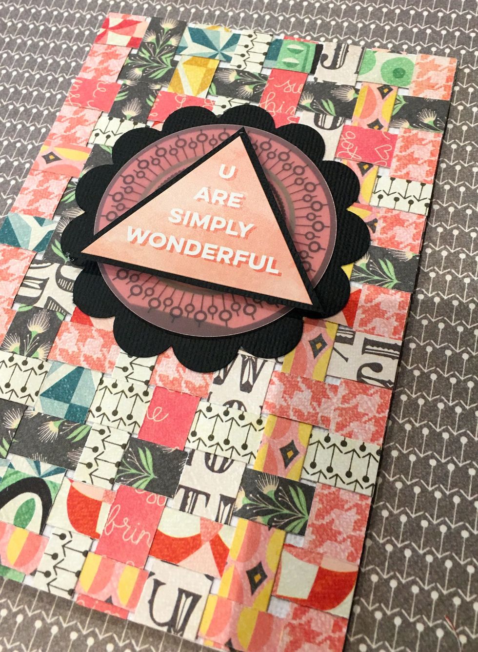 Select the Triangle Sticker from the Title StickerSheet with the sentiment \u201cU Are Simply Wonderful\u201d and layer on to the white card stock. Once layered, the white card stock circle should not show.