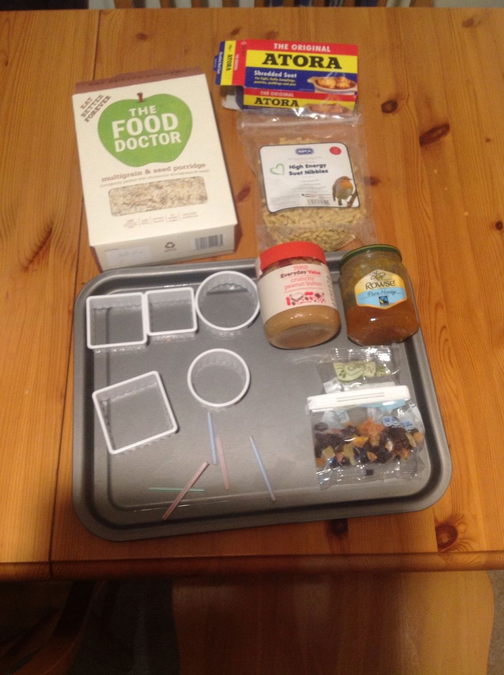 Select your tools (baking tray, pastry cutters, cut straws and cord) and ingredients (beef suet and bird feed suet, and a selection of: oats, flour, honey, peanut butter, bird seed, dried fruit).