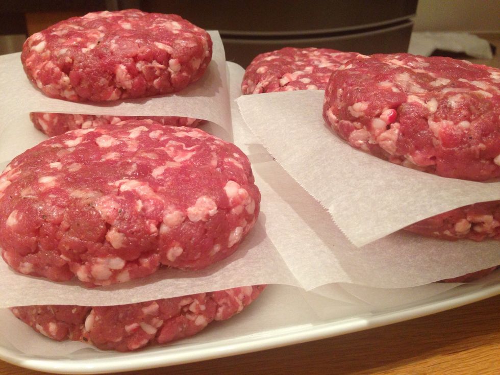 Separate each patty with parchment paper and place in fridge for at least two hours. You want them cold when they go onto the grill and you want to be food safe too, so take good care of minced meat.