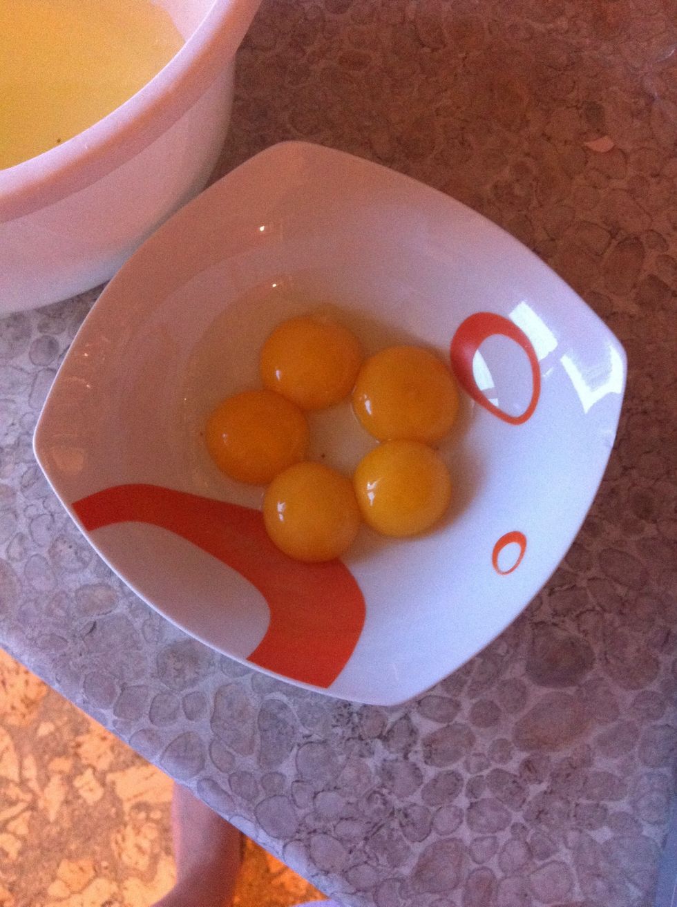 Separate egg white and egg yolks. Add yolks to the mixture of sugar and butter.
