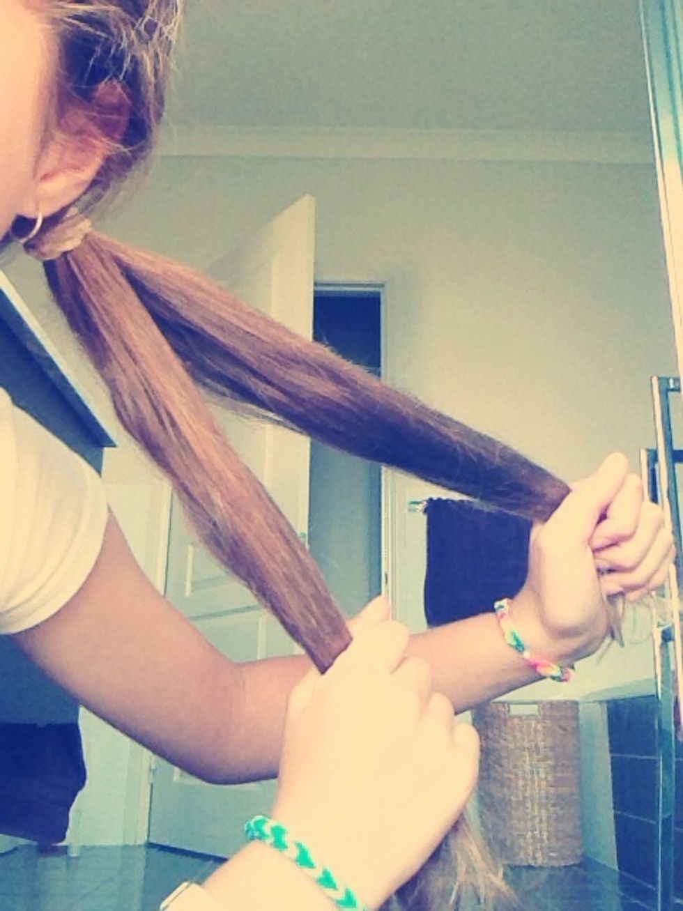 Separate hair into two equal pieces.