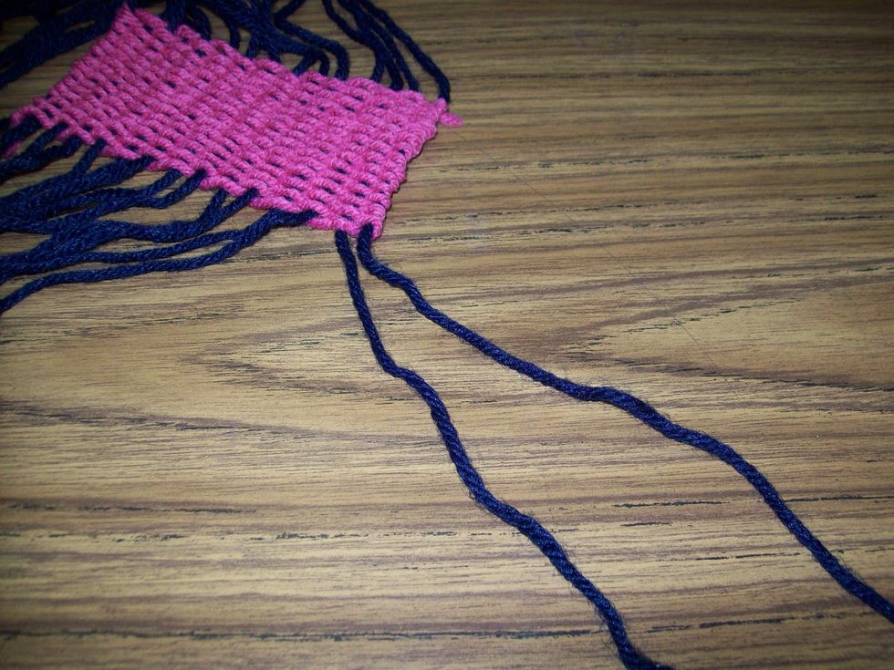 Separate the 2 warp strings on the end.