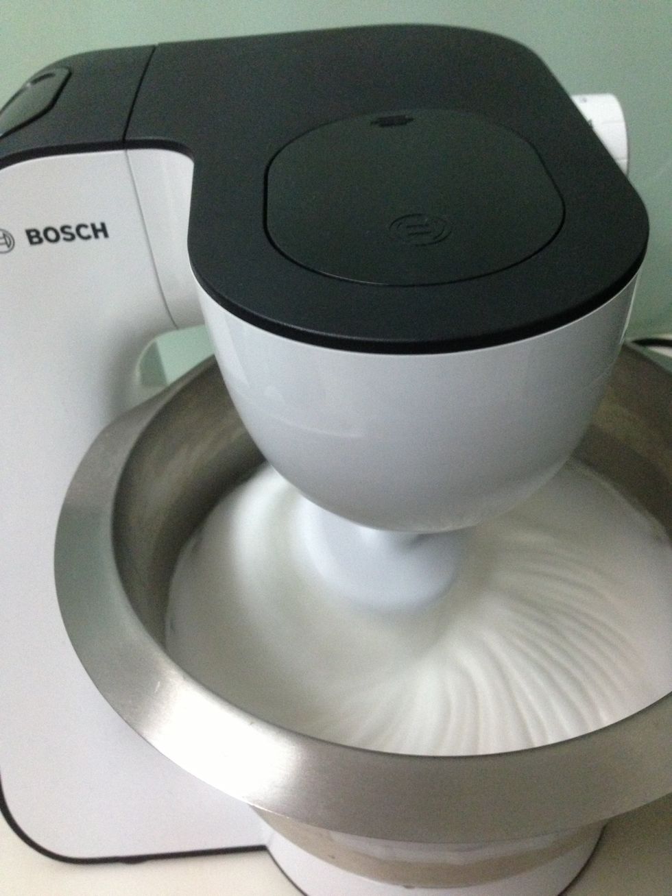 Separate the egg white from the yolks and whisk the egg white. Once foamy, add in the cream of tartar. Whisk until egg whites are firm and form peaks