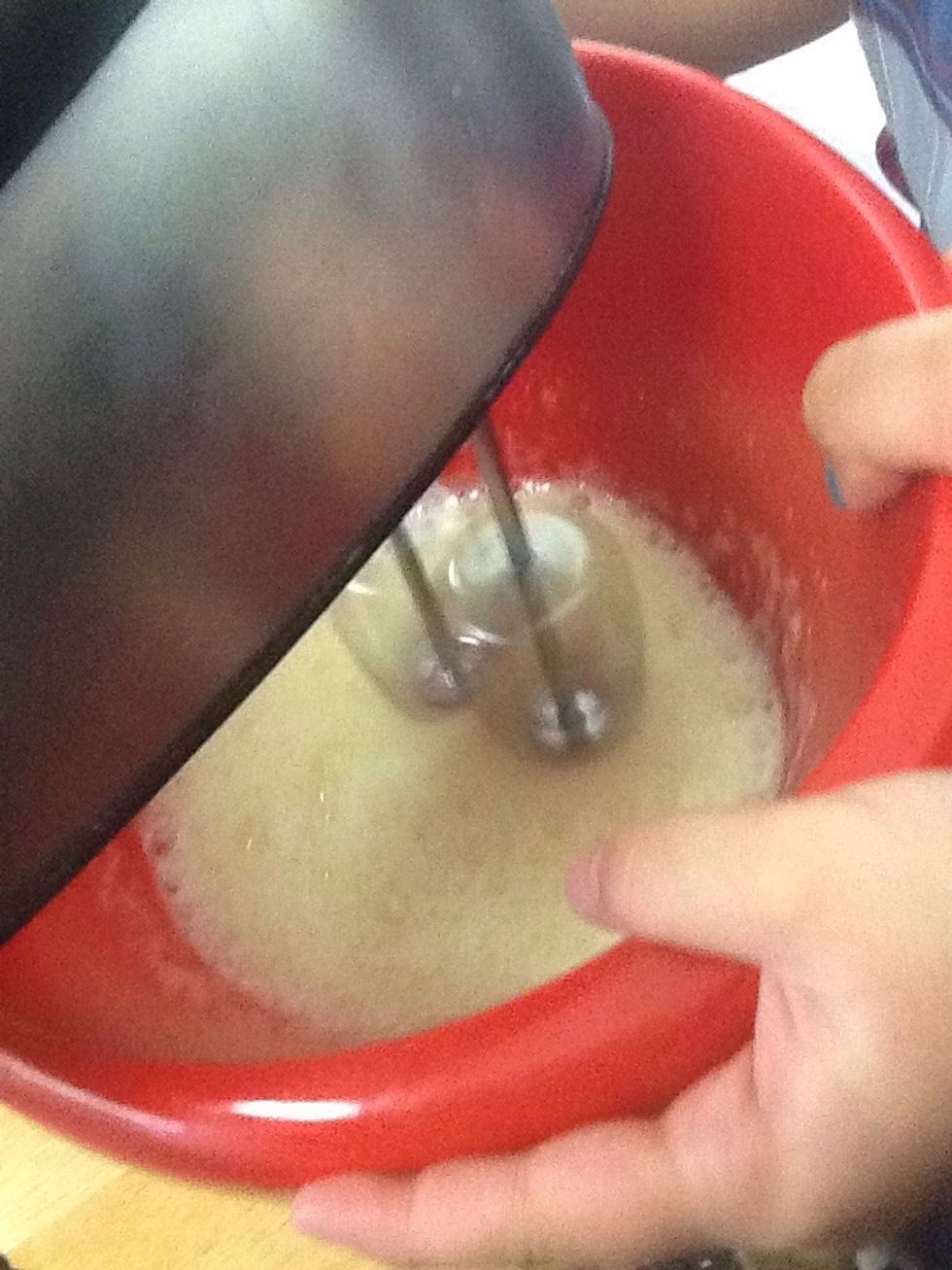 Separate the egg whites and beat until they form stiff peaks.