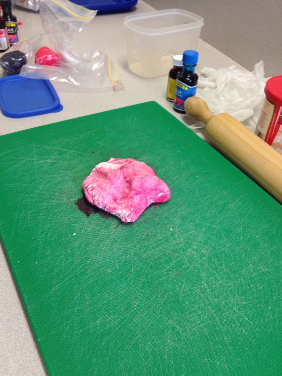 Separate the fondant into fist full sized pieces and colour with food colouring