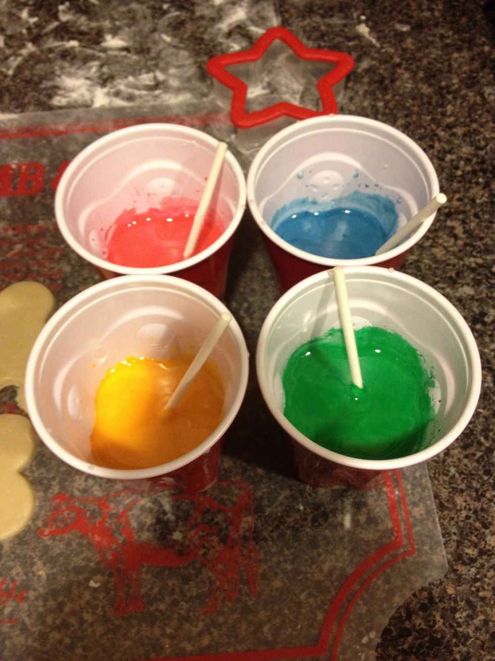 Separate the icing into 4 separate cups and add food coloring of any desired colors. Mix well, and decorate away!