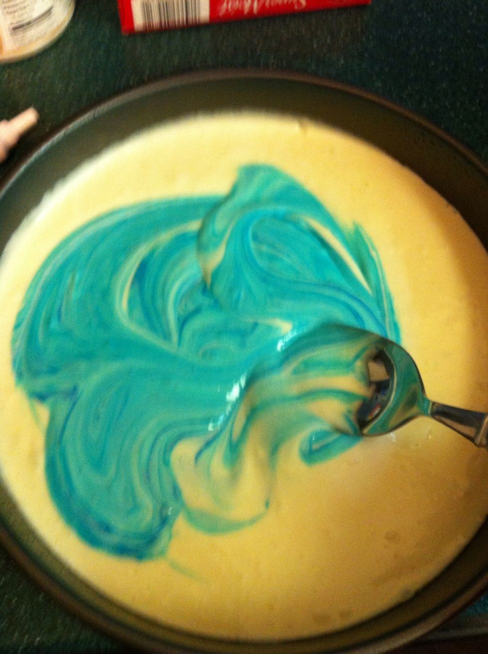 Separate the mix when smooth into two bowls, ( or three depending on how many colors you want) then add about 5 squirts of the food coloring of your choice. Mix with a spoon until all the cake is blue
