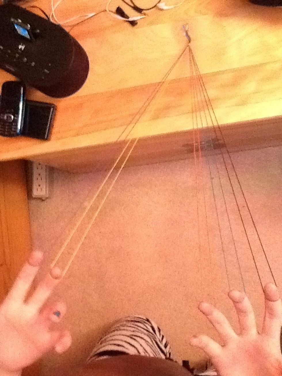 Separate the strings and put them on your fingers like so.