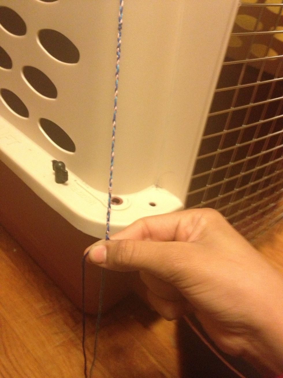 Separate the three strands again. While holding the two end strings take the middle string and slowly slide it up the braid (like a slide braid or snake braid)