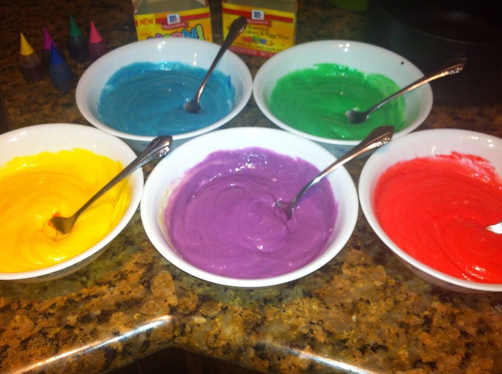 Separate white cake mix into separate bowls. Blend with different food coloring.
