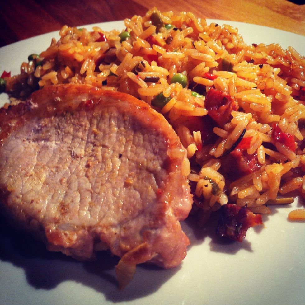 Serve a generous portion of the rice and a piece of pork.