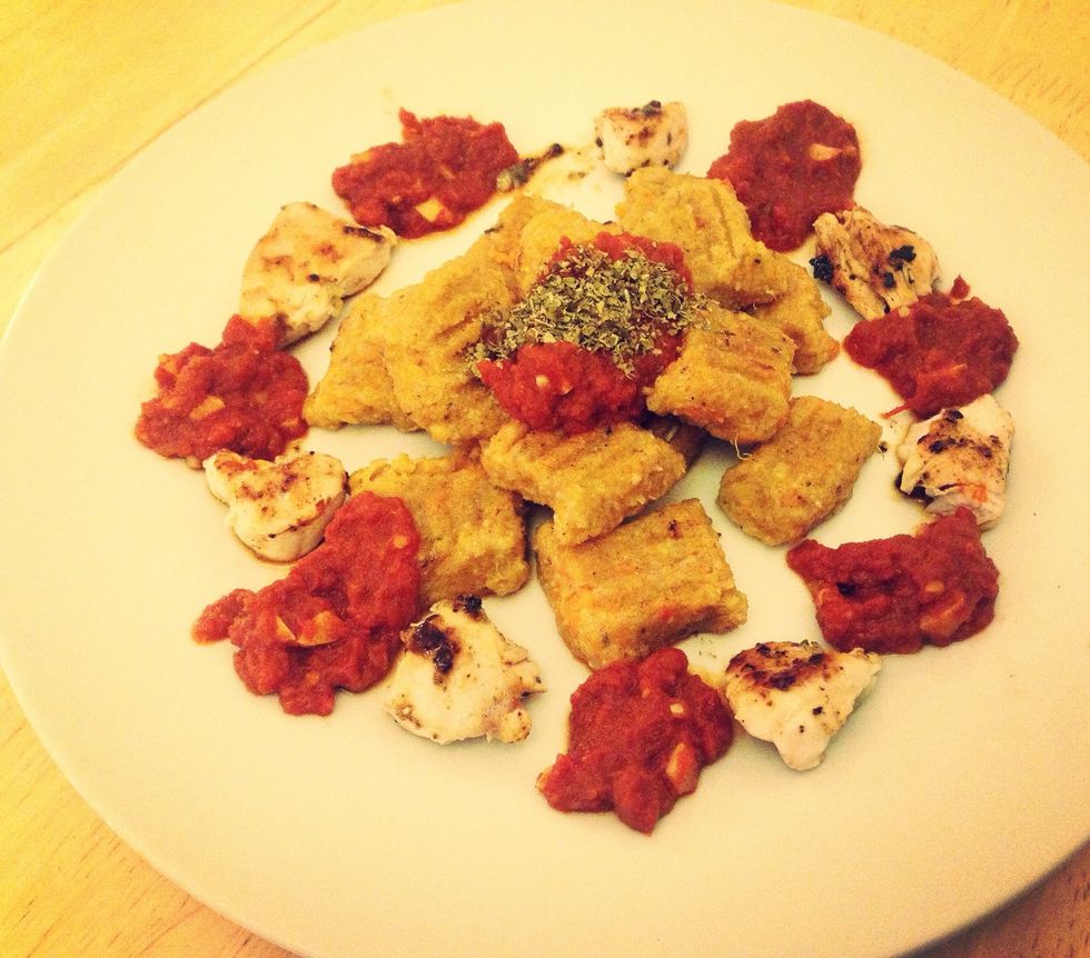 Serve gnocchi on a plate with chicken, tomato sauce and a pinch of mixed herbs. Enjoy\ud83d\ude0b