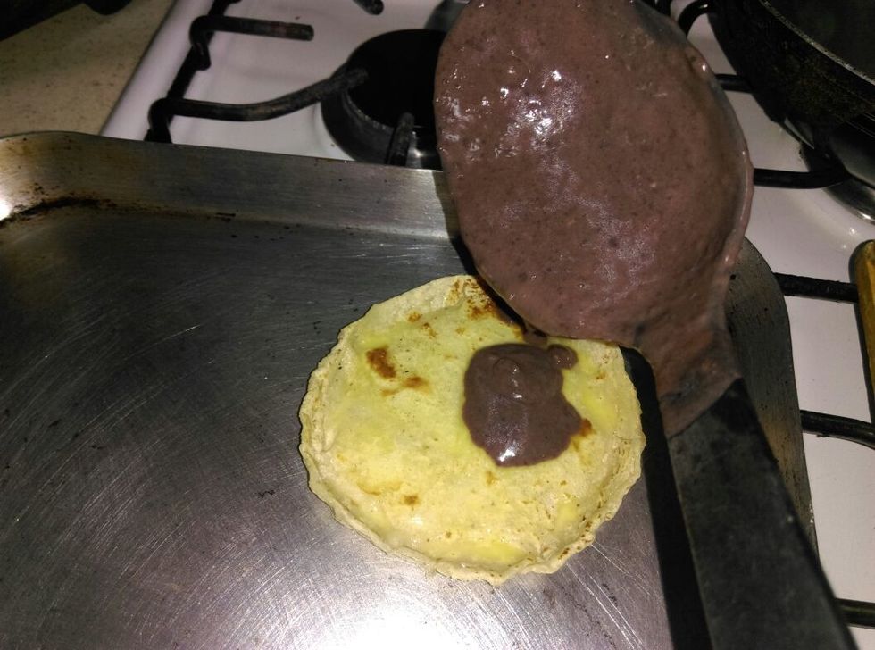 Serve the beans on the tortilla
