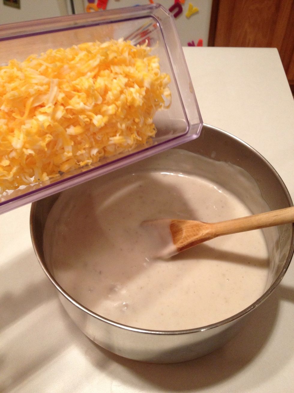 Set a little bit of Colby Jack cheese to the side. Add the rest to your sauce. Stir well.