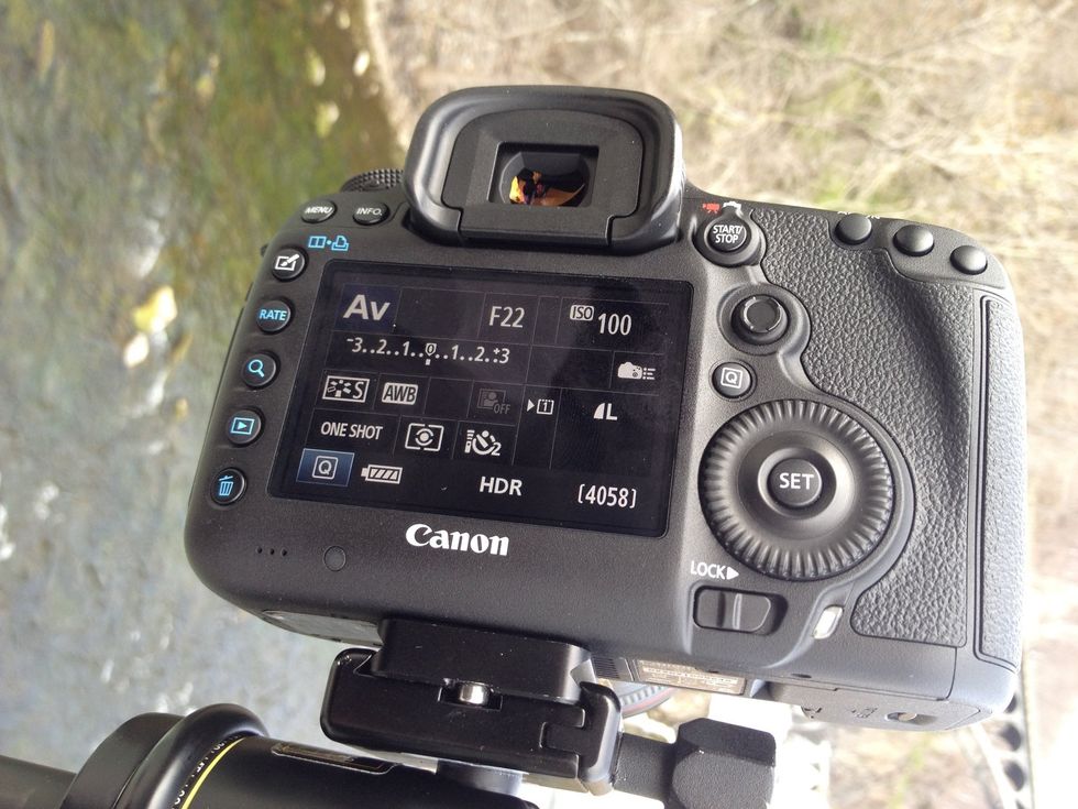 Set Aperture Priority Mode and aperture to f22, to capture flowing water. Use self timer to steady the camera as you shoot.