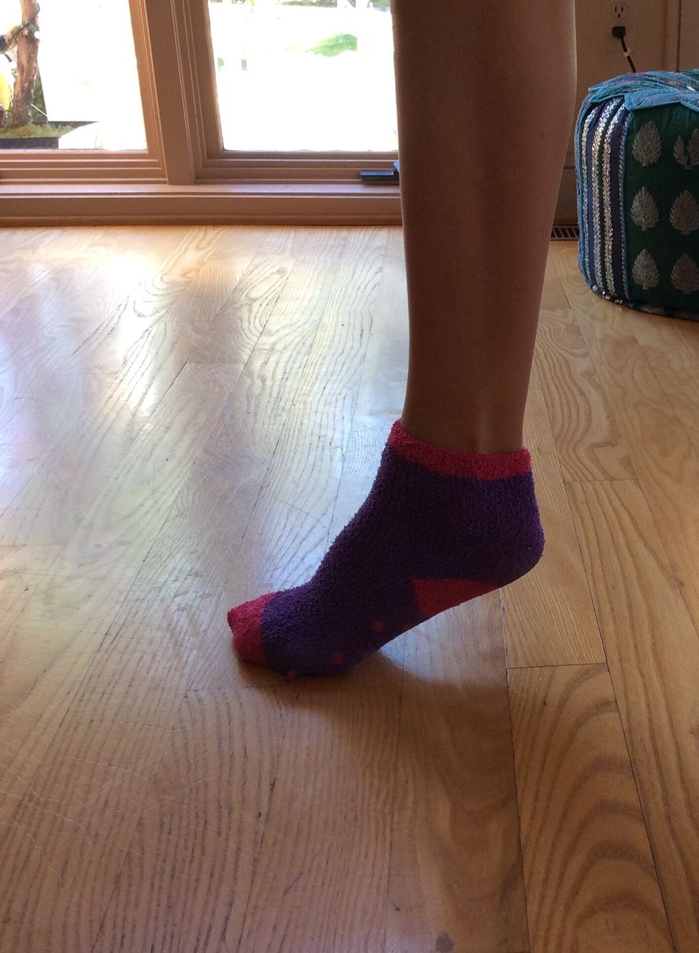 Set one foot into a position where it has only its toes on the ground and its heel up in the air.