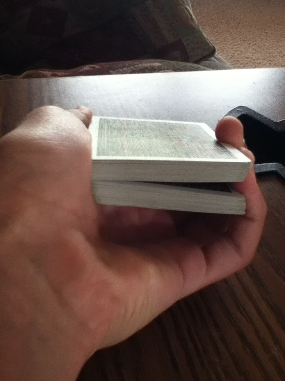 Set one on top of the other and have a pinky break between the two piles. Now you are ready to start the trick. :)
