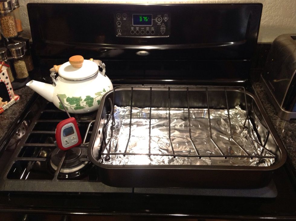 Set oven to 375 degrees F. Line pan with foil to reduce cleanup, spray rack with Pam.