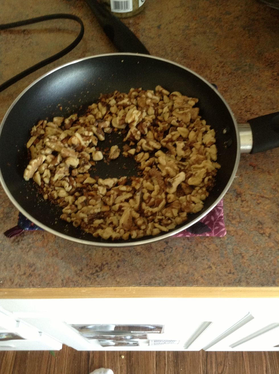 Set skillet on a pot holder to allow walnuts to cool