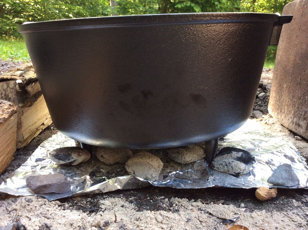 Set the 3 legged Dutch oven over the hot coals to preheat this too.