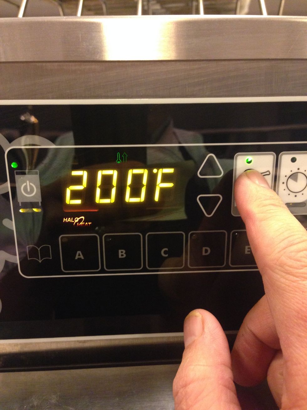 Set the cooking temperature to 200F (93C) by pressing this button and then adjusting with the up and down arrows.
