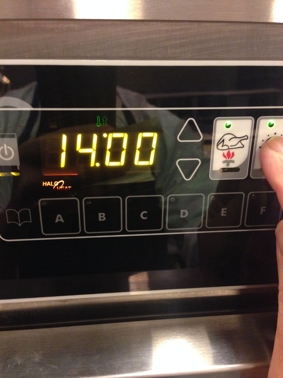 Set the cooking time to 14 hours by pressing the timer button (the one with the clock on it) and adjusting with the up and down arrows.
