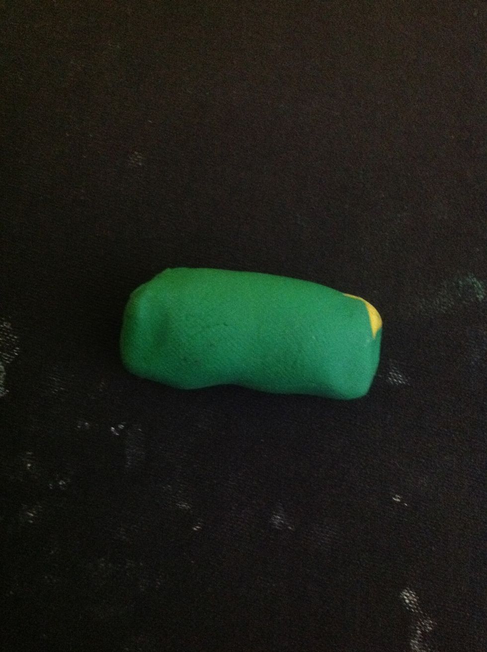 Set the head aside and make a body by rolling a piece of clay into a log shape.