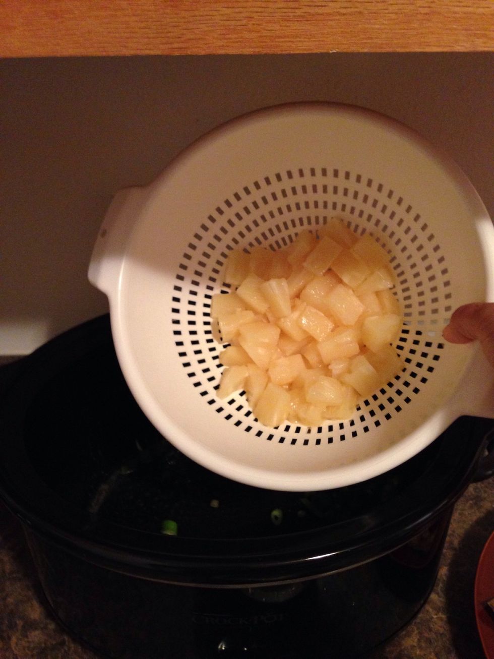 Set the juice aside for later and dump the pineapple chunks into the crock pot.