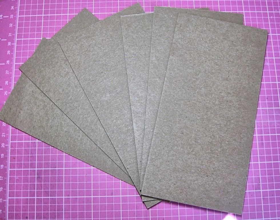 Set the open cover under heavy books overnight.  While waiting, work on the inside pages. Cut chipboard pages to measure 3 5/8" wide by 7" tall. Line the inside cover of the book with designer paper.