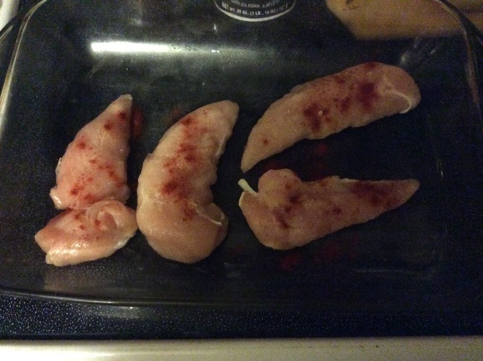 Set the oven to preheat 350 Lay chicken out and apply paprika, salt, pepper, and garlic powder.