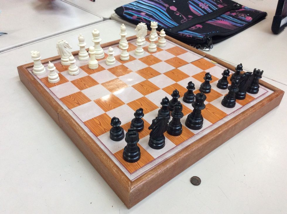 Set the queen next to the bishop on the left.