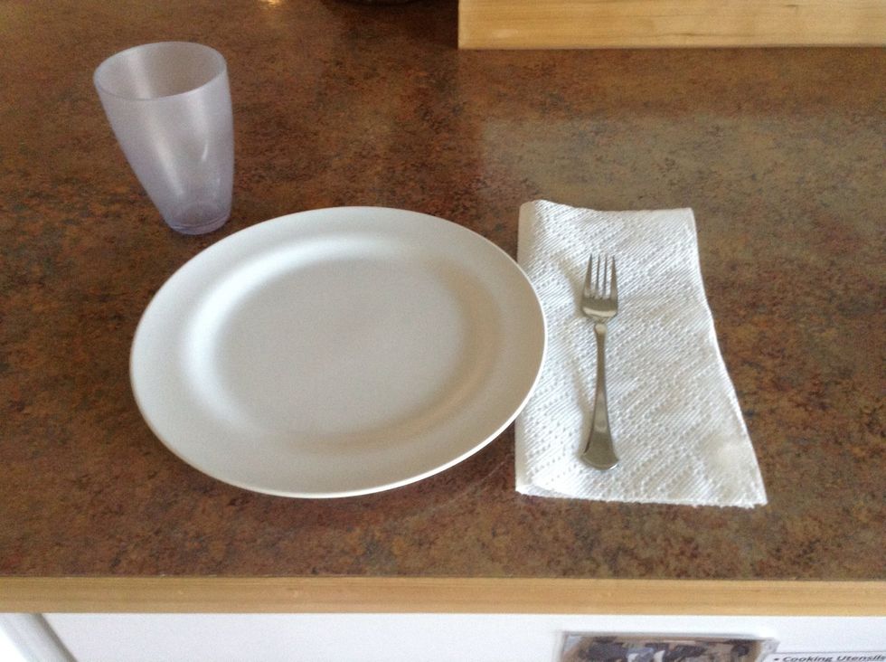 Set the table with plates, forks, napkins, and cups.