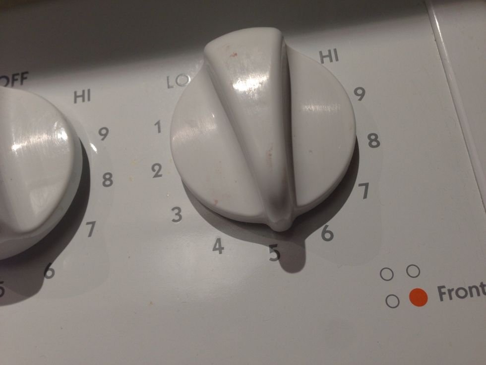 Set to medium. The lower the heat, the more even the eggs are cooked.