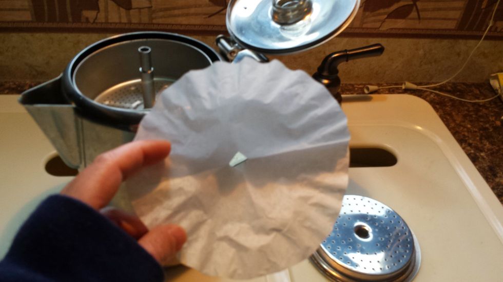 Set top basin back in. Take a coffee filter fold in quarters. Cut 1/4 inch off outside edge and clip the center out.