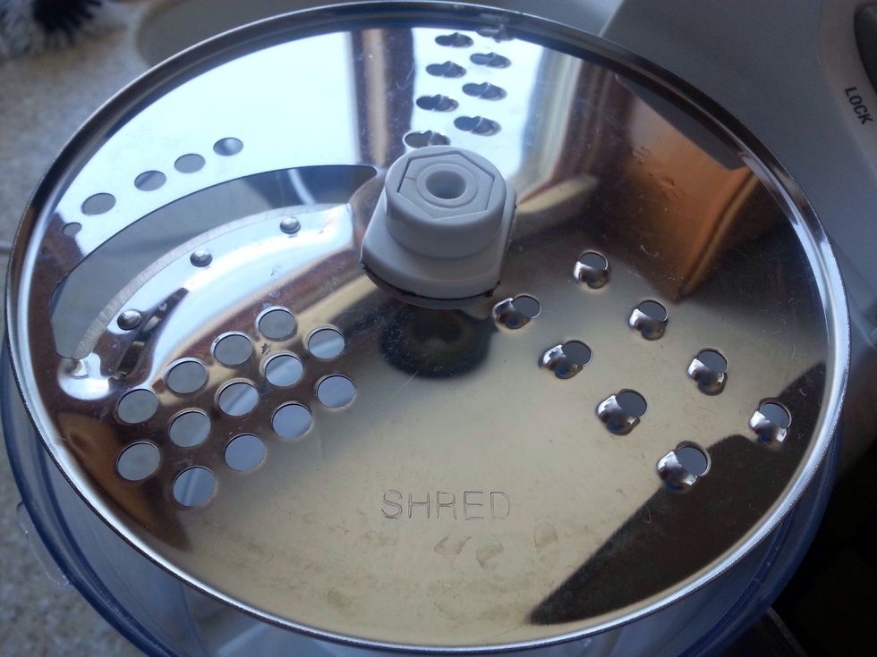 Set up food processor with grate blade.