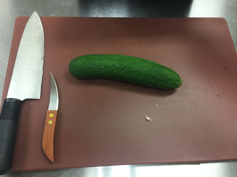 Set up the cutting board and place your cucumber on the top.