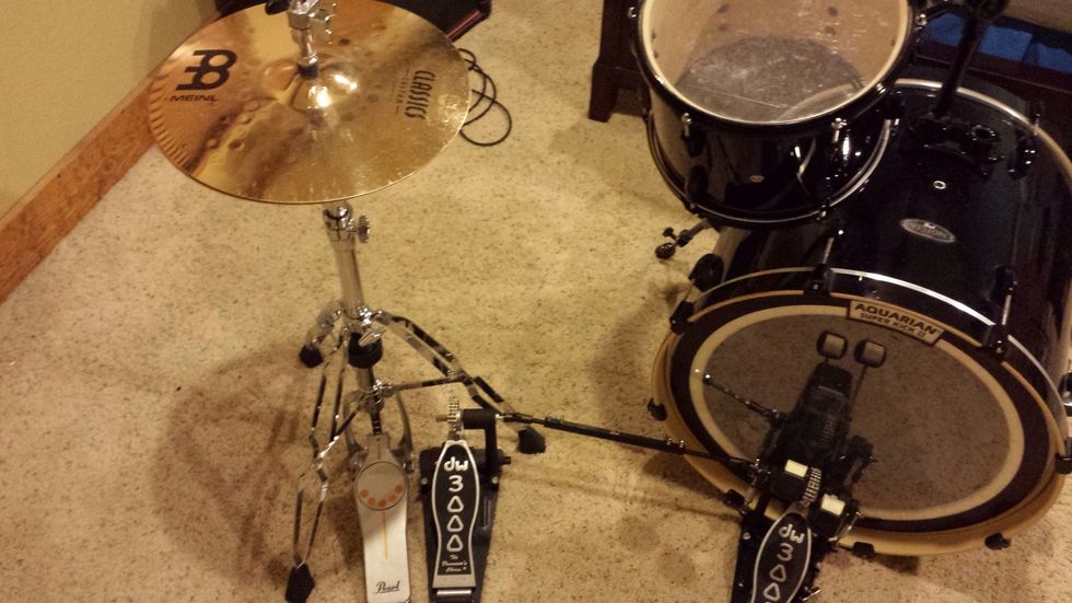 Set up the hi-hat stand with the pedal just the left of the left bass pedal. These two pedals should be close enough together that you can cover both pedals with one foot.