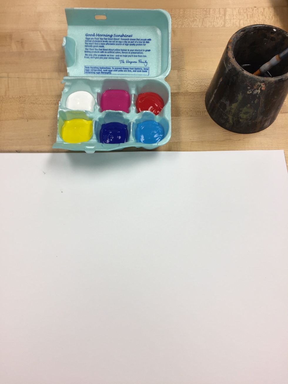 Set up your area with your supplies. Your supplies are the primary colors and white paint but also include magenta and dark blue.