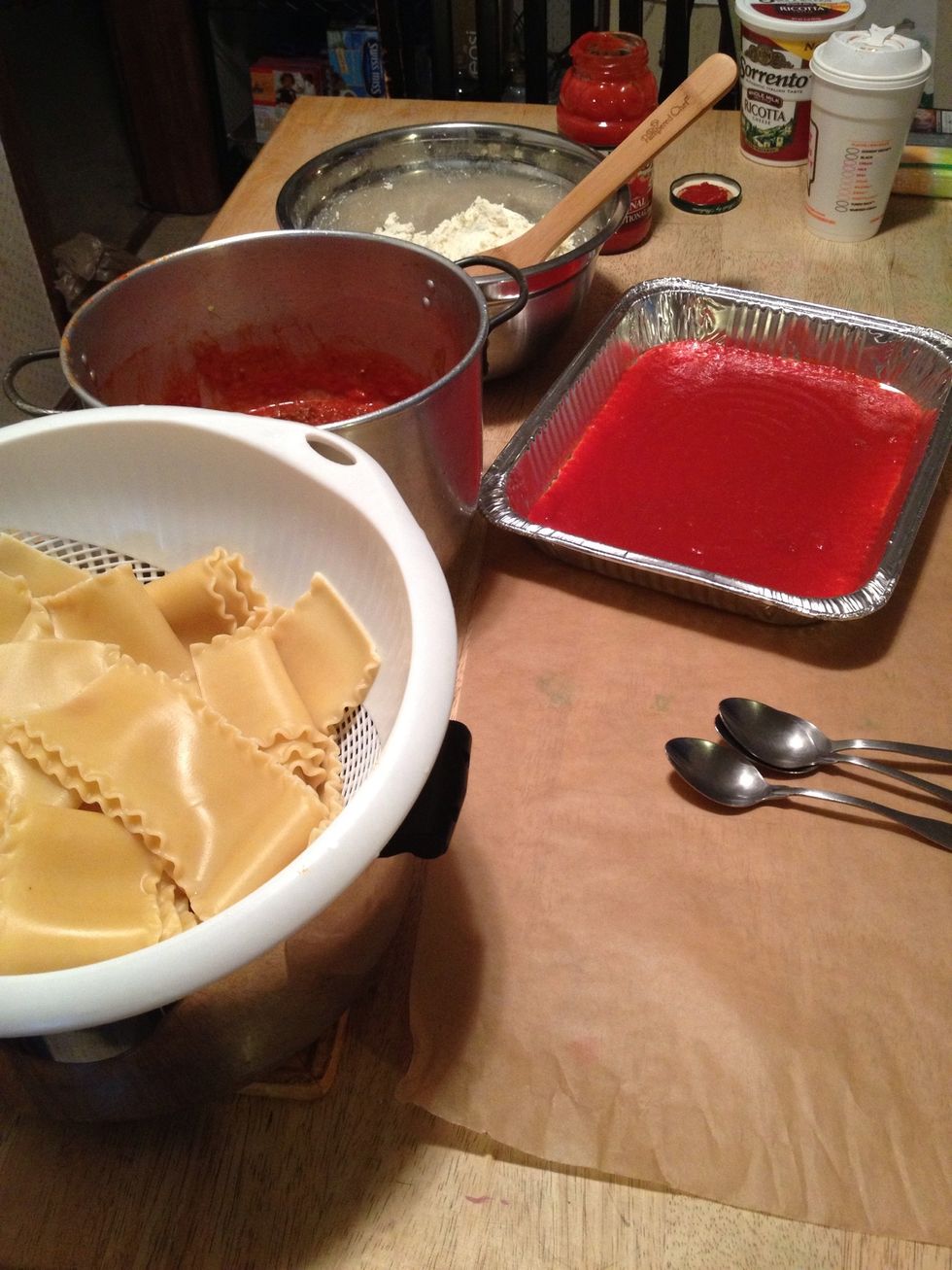 Set up your work station. Put parchment paper down on table. Line up all ingredients. Add a little sauce to bottom of pan from second jar of sauce.