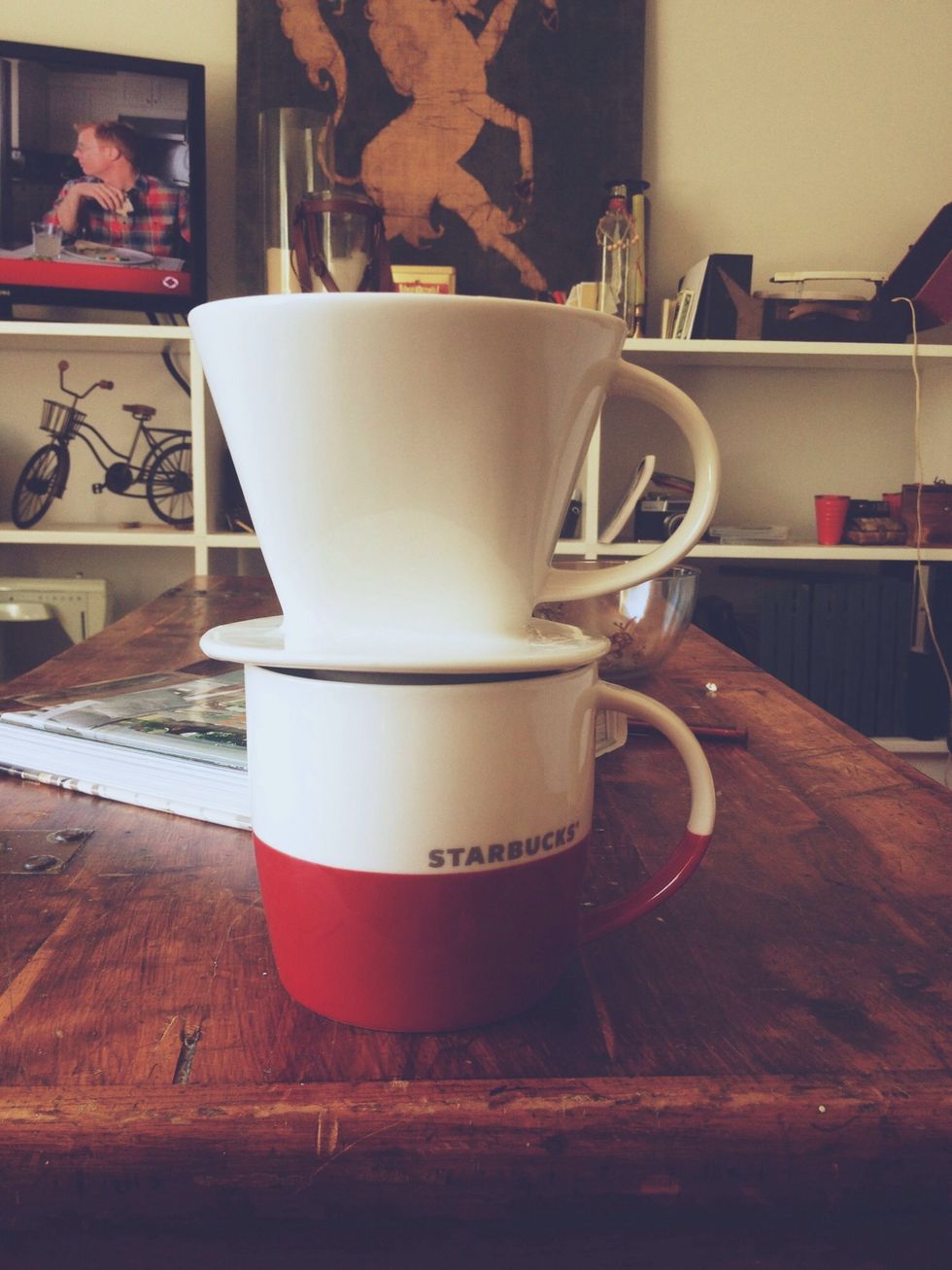 Set your coffee dripper on your cup. At this point you should have added your coffee to the rinsed filter, and now you're ready to pour.