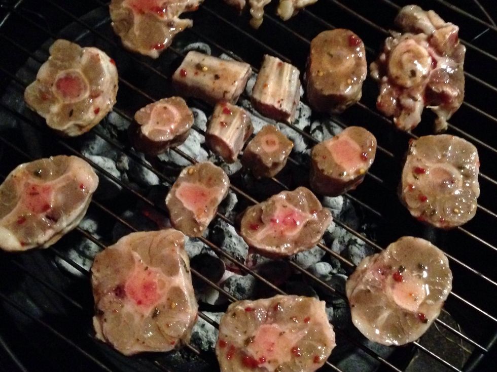 Set your ox tail in a circle on your grill just like this. Then put the lid on top and let it cook. Based ur oxtail every 15min. For an hour Then turn over and repeat base for another hour.