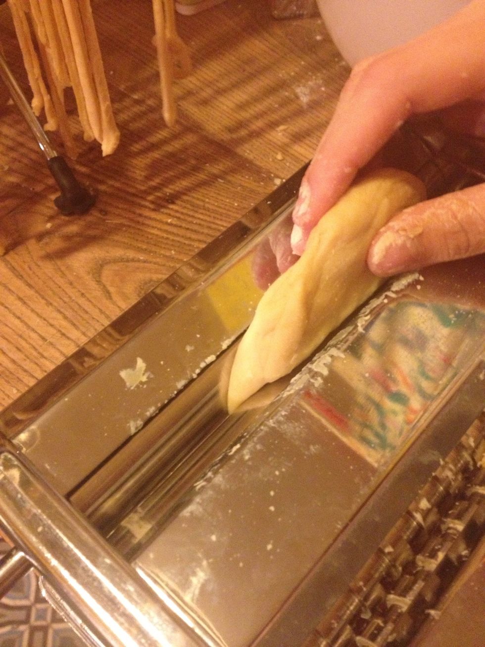 Set your pasta machine to the table. Divide the dough into several balls and pass a ball between two rollers ("lasagna"). Repeat reducing to the desired thickness.