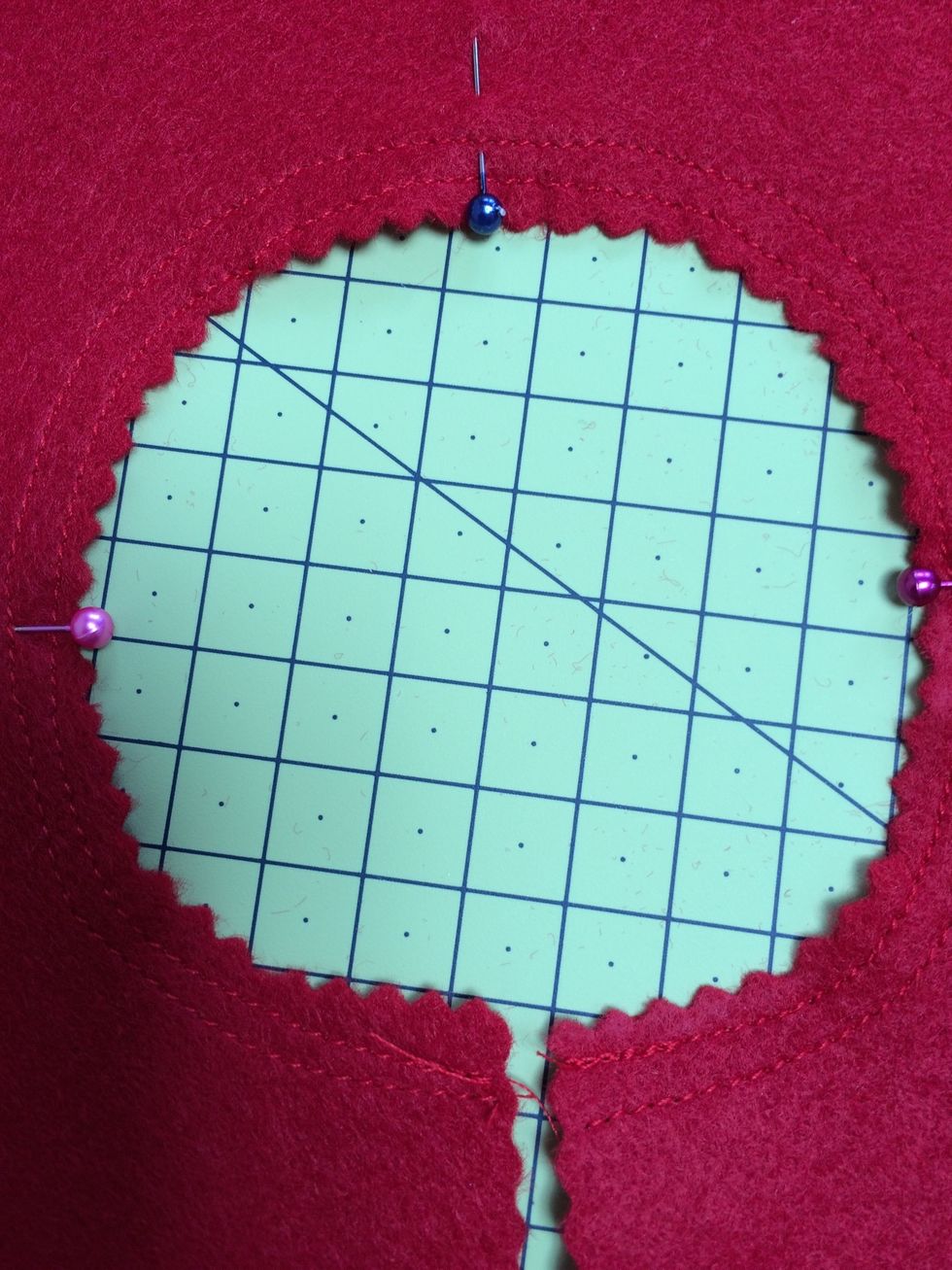 Sew a row or two around the neck opening to prevent it stretching . Fold into quarters and mark with pins as shown